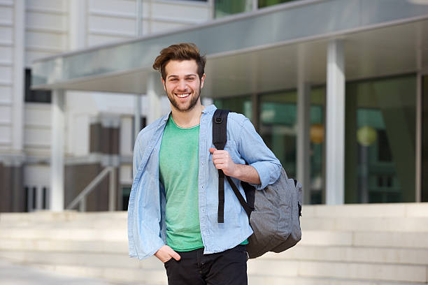 istock Cheerful college student standing outside with back 471379540