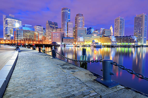 The beautiful Boston Harbor Skyline at night Financial District of Boston, Massachusetts viewed from Boston Harbor. boston harbor stock pictures, royalty-free photos & images