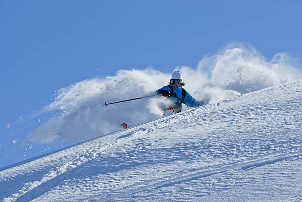 Powder Bliss Skier making a turn in fresh powder snow extreme skiing stock pictures, royalty-free photos & images