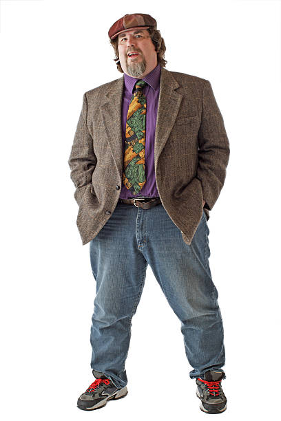 istock Large man smiles and stands with hands in pockets 471380867