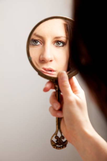 istock Closeup Mirror Reflection of a Woman's Face 471381239