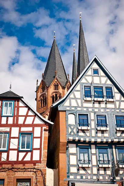 View of some beautifully restored buildings in the historic district of old downtown Gelnhausen, Germany in background the church "Marienkirche" built in 1170-1250. Gelnhausen was also the seat of Friedrich 1st Barbarossa (Emperor Barbarossa).