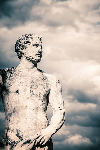 istock Ancient Male Statue against Stormy Clouds 471381715