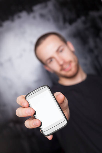 istock Guy showing screen of smartphone, focus on device 471382689