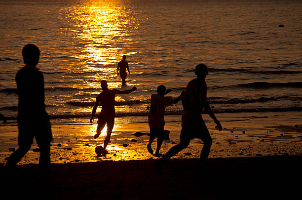 istock People playing football on silhouette scene. 471383147