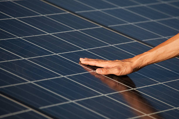 istock Hand touching for photovoltaic panels solar field 471383165