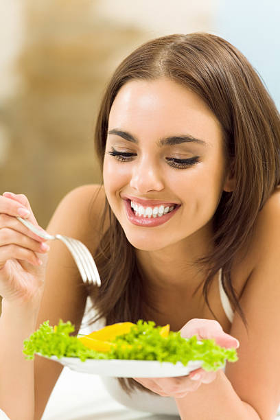 istock Woman with vegetarian salad, at home 471383245