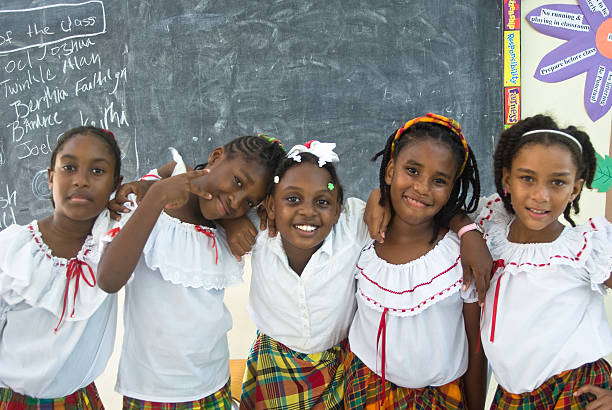 Castries St Lucia - October 27, 2011; Five schoolgirls in classroom at the Eucharist Lewis Seventh-Day Adventist Primary School posing happily for camera in traditional creole costume on Jounen Kweyol (Creole Day) 2011.
