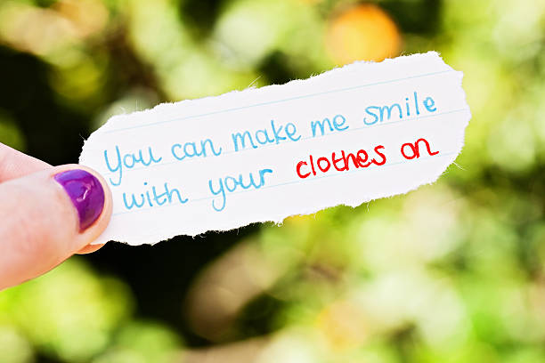 istock Female hand holds hand-drawn cheeky flirtatious message 471385061