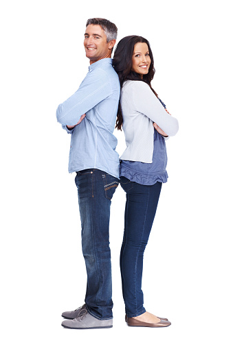 Full-length portrait of a happy couple standing back to back - Isolated