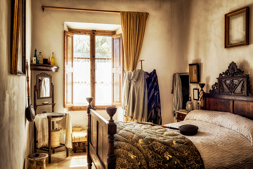 ancient old bedroom of a spanish manor house - decorated in majorcan country house style \
