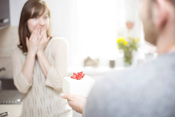 istock Man giving woman a gift for her birthday 471387576