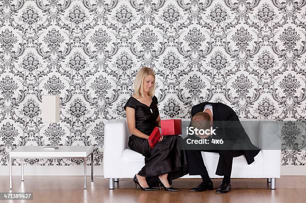 Woman Looking At A Gift Given By Her Husband Stock Photo - Download Image Now - Gift, Boyfriend, Couple - Relationship