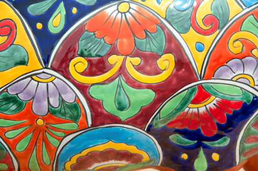 Handcrafted, hand-painted Mexican pottery. Stenciled ceramic glaze suggest soft focus and edges.