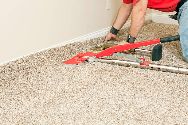 istock Installer Using Carpet Stretcher on New Bedroom Floor 471389573