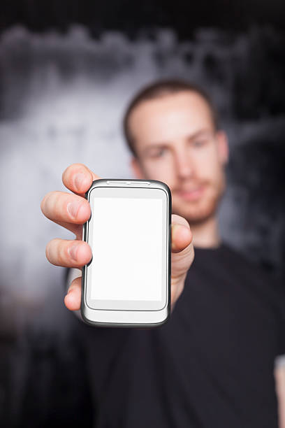 istock Men showing screen of cell phone, focus on smartphone 471389879