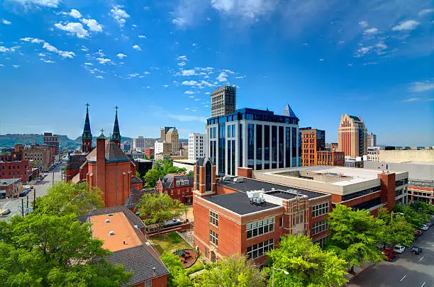 Photo of Skyline view of small city, brick buildings with blue sky