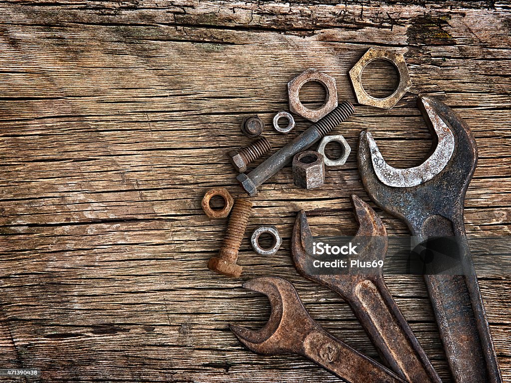 Old wrenches on the nuts and bolts a wooden  background Old wrenches on the nuts and bolts a wooden  background  2015 Stock Photo