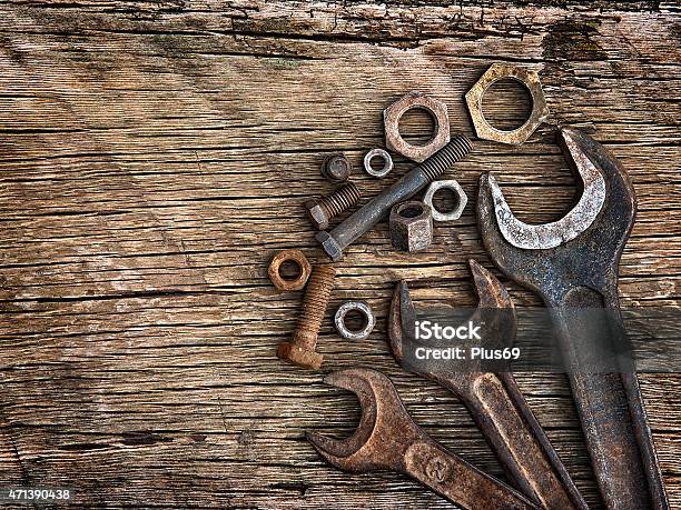 Old Wrenches On The Nuts And Bolts A Wooden Background Stock Photo - Download Image Now