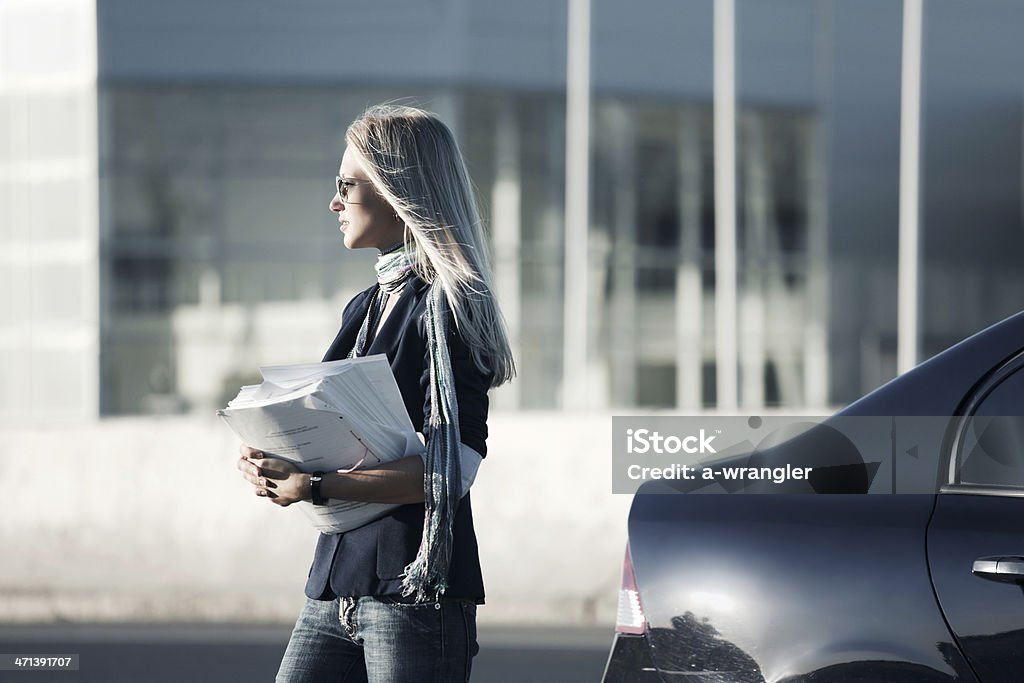 Young businesswoman with financial reports other photos of "People and Car" series: Adult Stock Photo