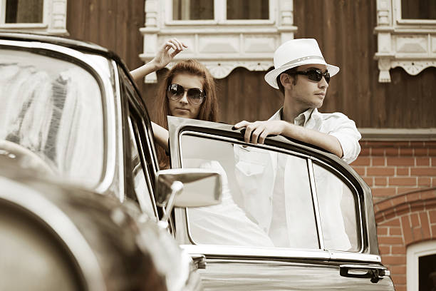 istock Young couple with a retro car 471391731