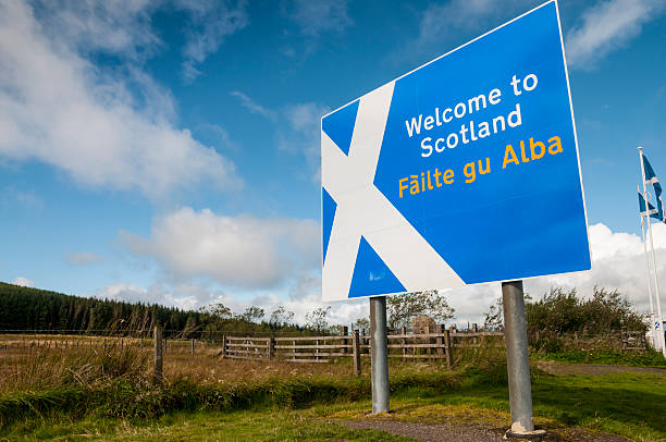 Welcome to Scotland sign at Scottish border "Welcome to Scotland" sign showing saltire flag emblem at roadside on Scotland/England border. Gaelic translation "Failte gu Abla" shown underneath in yellow text. scotland border sign stock pictures, royalty-free photos & images