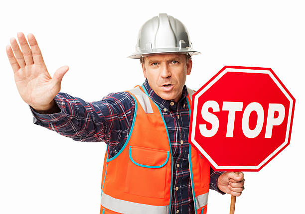 Male Construction Worker Holding a Stop Sign - Isolated