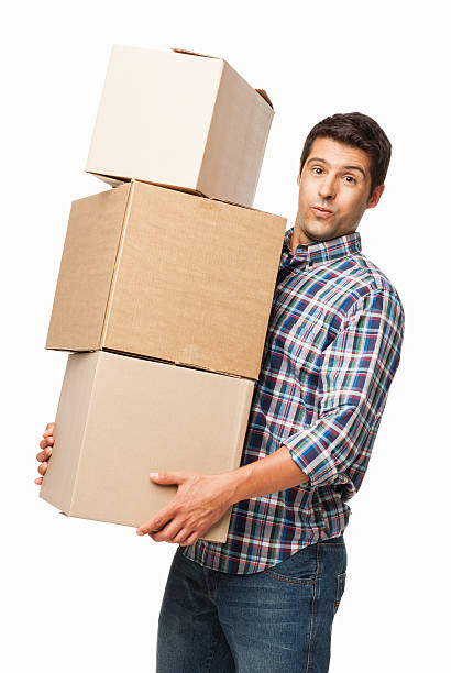 Man Carrying Heavy Stack Of Cardboard Boxes - Isolated