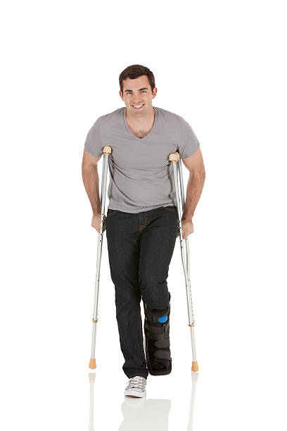 istock Injured man walking with the help of crutches 471395885