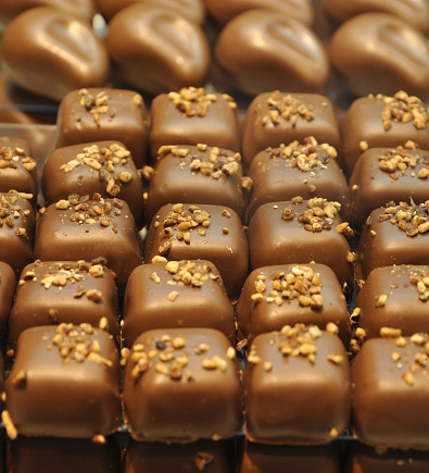 Chocolate candies with nut toppings.