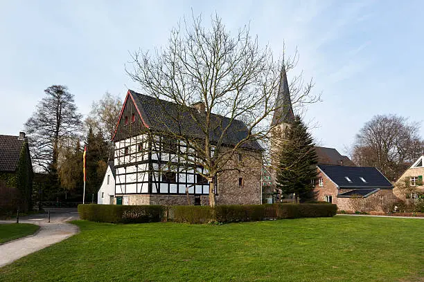 Half-timbered building, the so-called "Haus am Quall", and the belltower of Nikolaikirche church at Haan-Gruiten