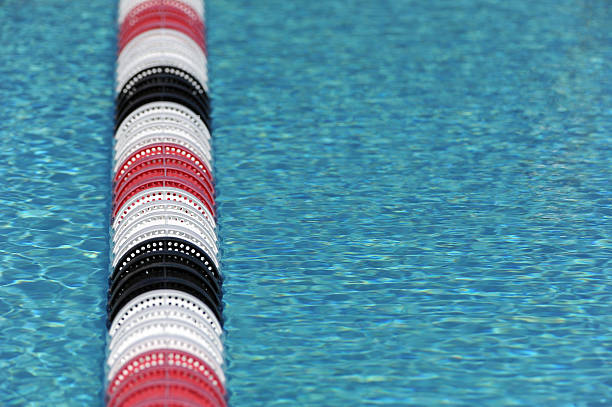 sport swimming pool sport swimming pool of 25 meters with lanes and blue water - ready for competition swimming pool lane ropes stock pictures, royalty-free photos & images