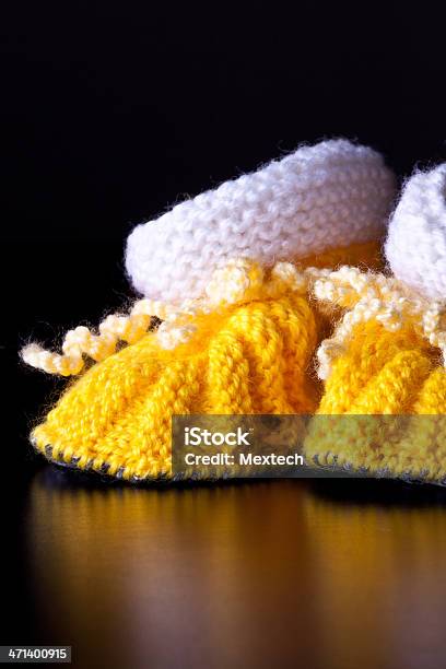 Knitted Handmade Babys Bootees Stock Photo - Download Image Now - Art And Craft, Beauty, Black Background