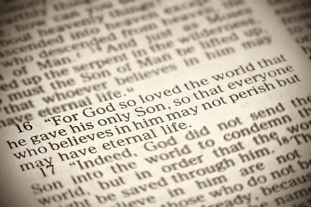 The famous John 3:16 Bible verse, "For God so loved the world that he gave his one and only Son..." with a sepia tone.