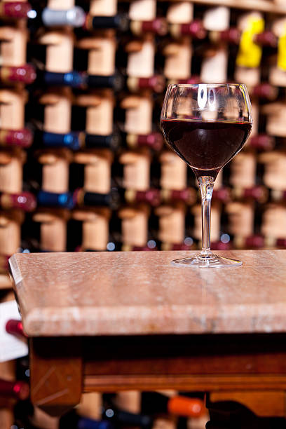istock Glass of Wine on Table in Cellar 471403235