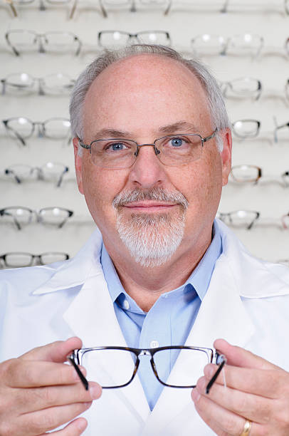 istock Optometrist Offering Eyeglasses to Try On 471403539