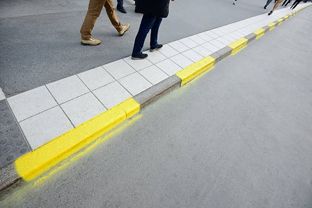 Pedestrians on sidewalk,yellow road markings
