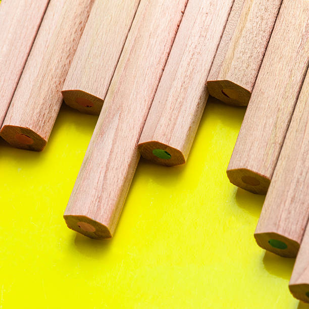 istock Wooden pencils on a flashy yellow background table 471404432