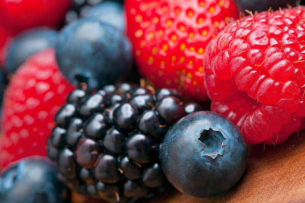 istock Mixed berries on a wooden background 471404564