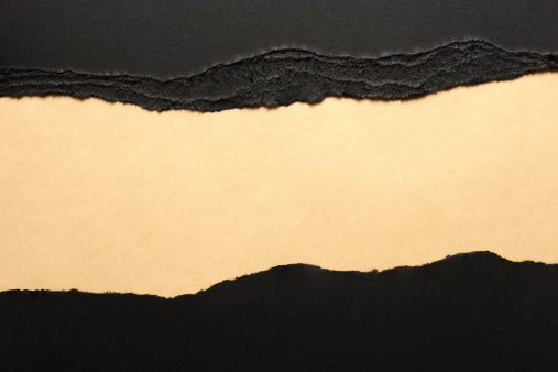 Black torn paper borders on brown wrapping paper.