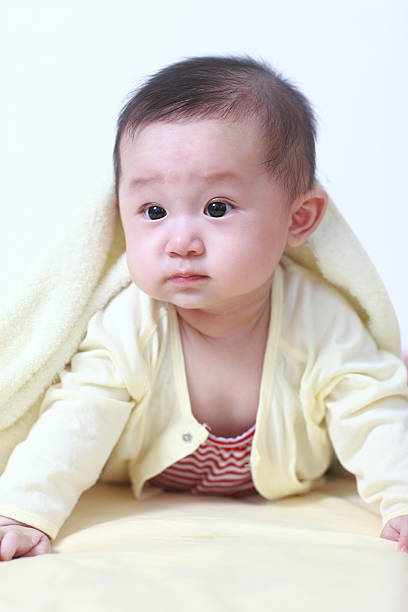 istock Cute asia baby on the bed 471404795