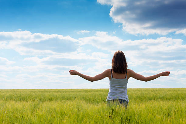 istock Girl in a green field 471405147