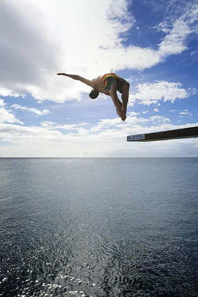 Photo of Guy jumping off a Highdive Board in the Ocean (XXXL)