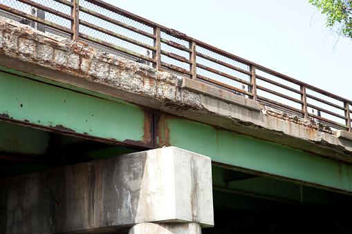 The concrete of this highway bridge has deteriorated over the years.  The bridge is located on Interstate 490 in Pittsford, NY, USA.