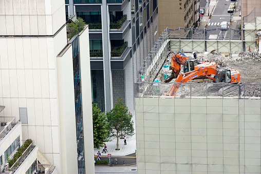 Tokyo, Japan - October 04, 2014: excavators demolishing a building located in Uchisaiwaicho, Chiyoda District.
