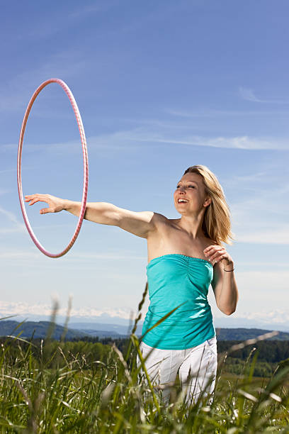 istock Blond mature womanplays with hula hoop 471407925