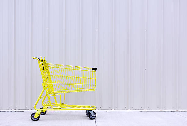 istock Yellow Shopping Cart Against Wall 471407944