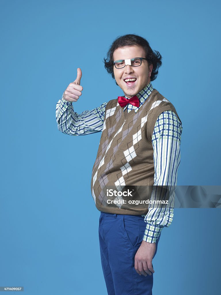 Nerd student  making Ok hand sign Nerd student  making Ok hand sign over blue background Ugliness Stock Photo