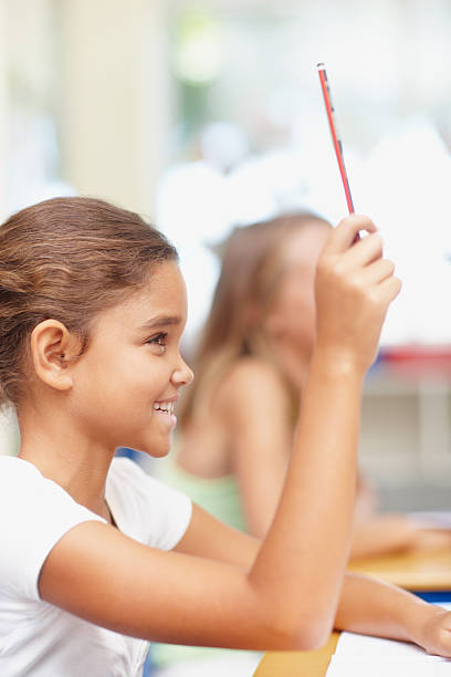 Top achiever of the class Profile of a sweet schoolgirl holding up her pencil to answer a question - copyspace report card stock pictures, royalty-free photos & images