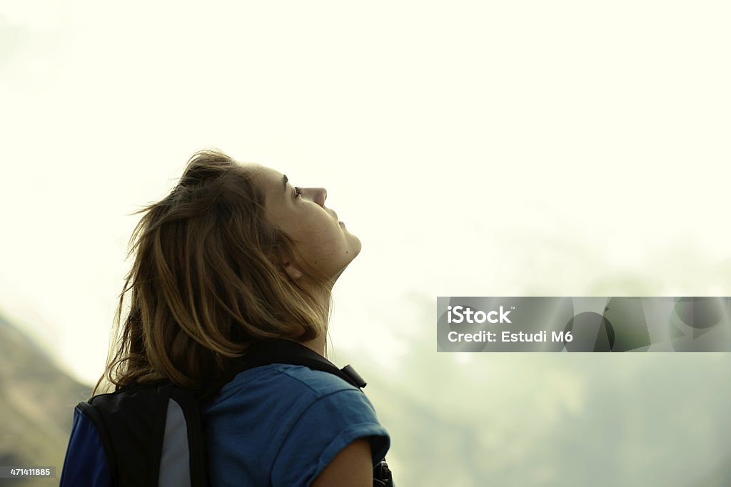 Young woman enjoying the air Young pretty woman looking up and enjoying the air and the nature. 20-24 Years Stock Photo